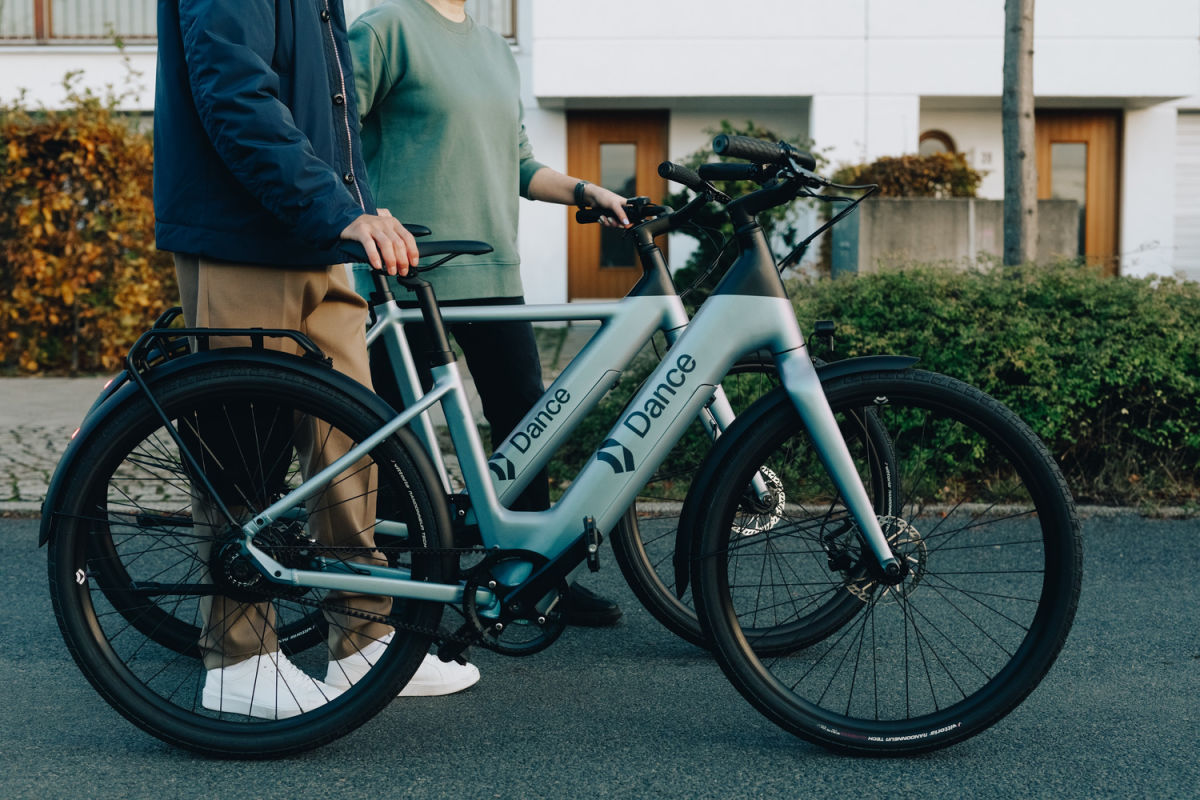 Two people pushing Dance bikes